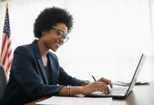 Smiling person working with a green card lawyer online to apply for green card, filling out forms with ease.